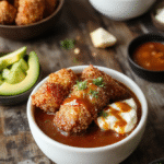 A vibrant bowl featuring golden crispy breaded pork cutlet sliced over steamed white rice, topped with shredded cabbage, drizzled with rich homemade tonkatsu sauce, garnished with chopped green onions. The bowl is colorful and inviting, styled with a clean wooden table background, emphasizing textures of crispy breading and glossy sauce.